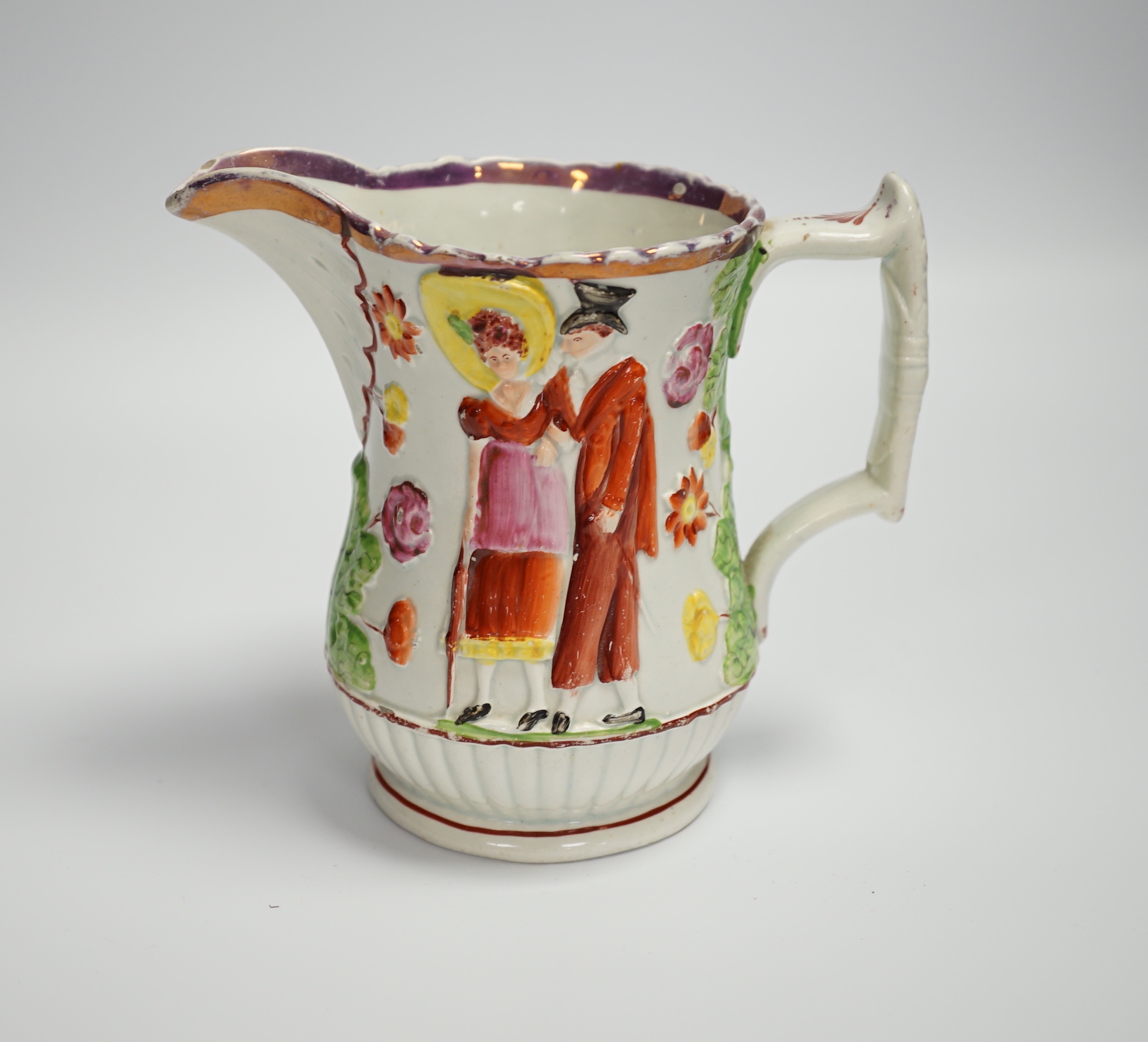 A relief moulded 19th century Staffordshire pearlware jug, 15cm high